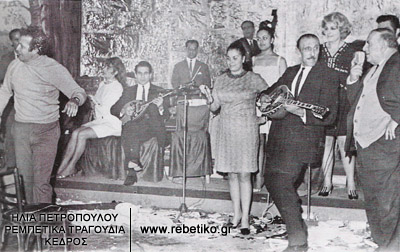 Μία σκηνή στον Ξενύχτη, το 1968. Ο Παπαϊωάννου παίζει μπουζούκι, κάποιος κουραδόμαγκας χορεύει, κι οι φίλοι του σπάνε πιάτα.
